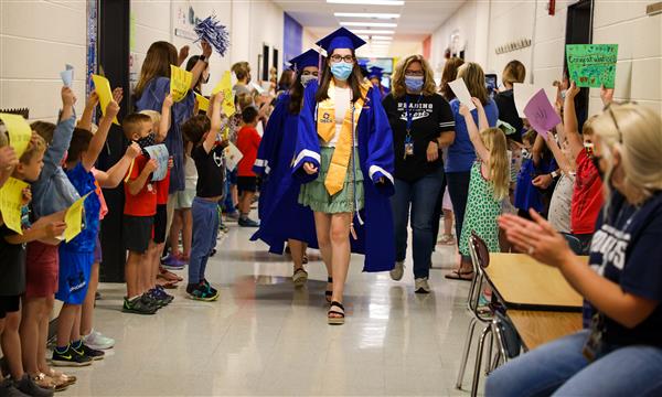Seniors walk through the halls of an elementary school